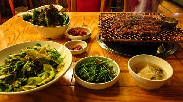 Typical Korean food, charcoal BBQ with banchan