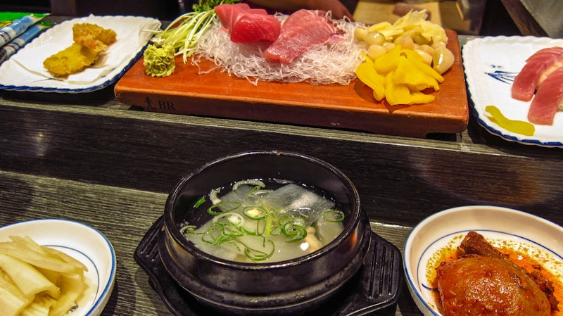 Assortment of seafood and side dishes at Mido Tuna