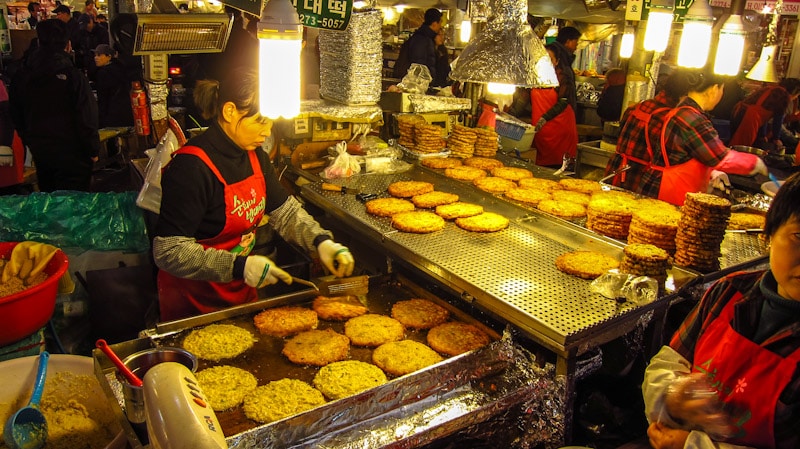 Vendor selling bindaetteok at Gwangjang Market in Seoul