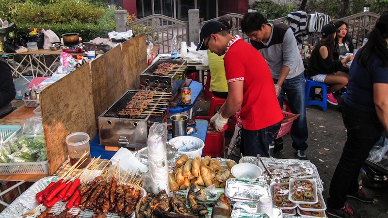 Skewers of chicken and pork on the grill at Daehangno Philippine Market in Seoul