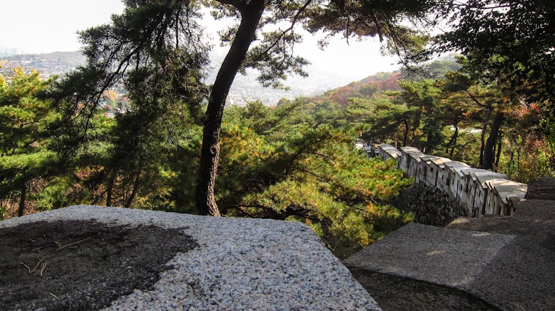The fortress wall leading down hill from Sukjeongmun Gate