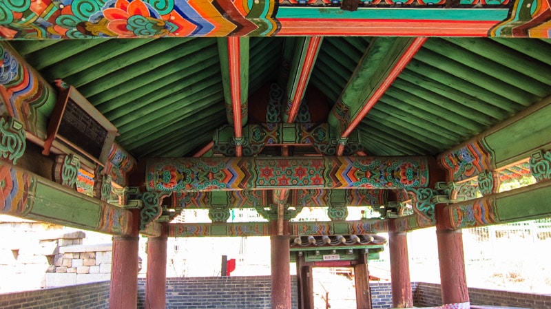 A view of the painted underside of the roof inside the gatehouse of Changuimun Gate