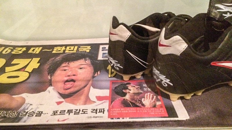 Cleats and newspaper from 2002 Seoul World Cup