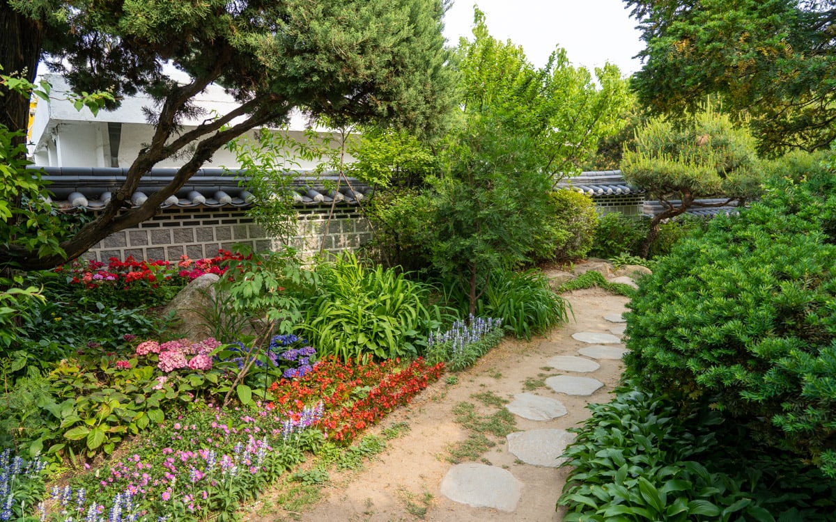 Flowers lining a walking path through the sarangchae garden, Baek In-je House, Seoul, Korea