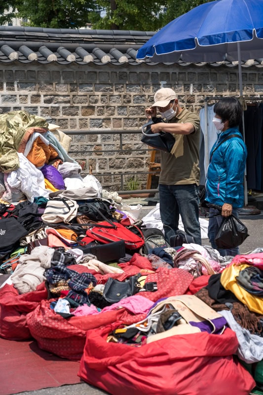 A man shopping for a bag at Dongmyo Flea Market