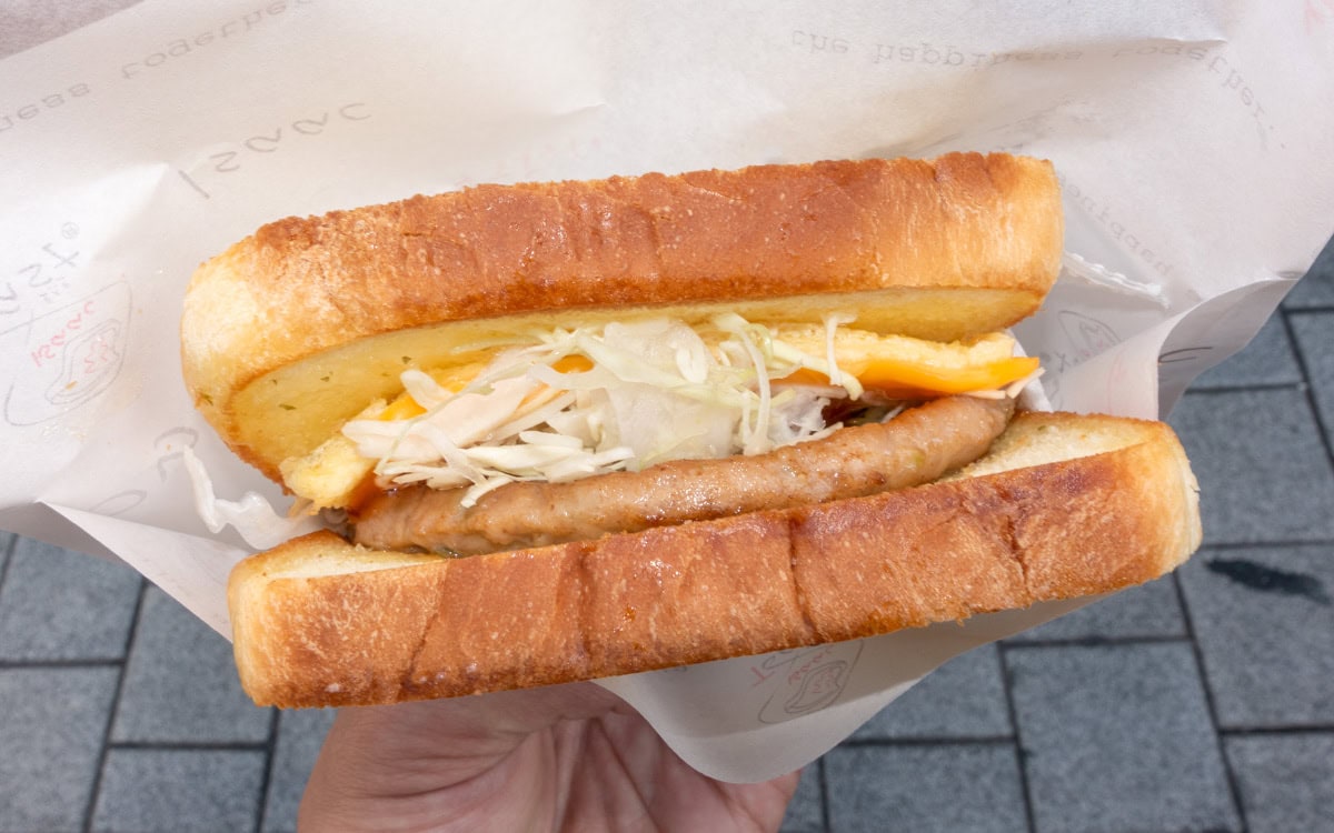 Korean street toast sandwich with egg, cabbage, cheese, and sausage at Dongmyo Flea Market